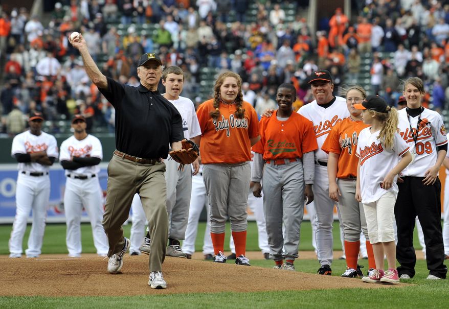 In this April 6, 2009, file photo, then-Vice President Joe Biden throws out the first pitch prior to the Baltimore Orioles and the New York Yankees opening day baseball game at Camden Yards in Baltimore. (AP Photo/Gail Burton, File)  **FILE**