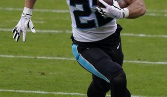 Carolina Panthers running back Christian McCaffrey (22) runs toward the end zone to score against the Kansas City Chiefs during the first half of an NFL football game in Kansas City, Mo., Sunday, Nov. 8, 2020. (AP Photo/Jeff Roberson)