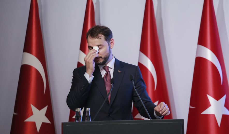 FILE - In this Friday, Aug. 10, 2018 file photo, Berat Albayrak, Turkey&#39;s Treasury and Finance Minister, wipes his forehead as he talks during a conference to ease investor concerns about Turkey&#39;s economic policy. Albayrak, announced his resignation on social media Sunday, Nov. 8, 2020. He said on Instagram that he was stepping down from his post for health reasons and would spend more time with his family. Albayrak, 42, was appointed minister of finance and treasury in July 2018, having previously been energy minister for nearly three years. (AP Photo/Mucahid Yapici, File)
