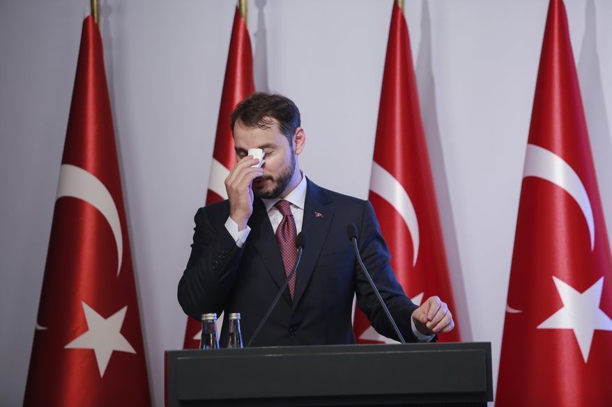 FILE - In this Friday, Aug. 10, 2018 file photo, Berat Albayrak, Turkey&#39;s Treasury and Finance Minister, wipes his forehead as he talks during a conference to ease investor concerns about Turkey&#39;s economic policy. Albayrak, announced his resignation on social media Sunday, Nov. 8, 2020. He said on Instagram that he was stepping down from his post for health reasons and would spend more time with his family. Albayrak, 42, was appointed minister of finance and treasury in July 2018, having previously been energy minister for nearly three years. (AP Photo/Mucahid Yapici, File)