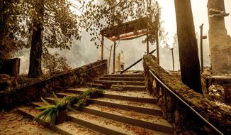 FILE - In this Sept. 28, 2020, file photo, a staircase remains at the Restaurant at Meadowood, which burned in the Glass Fire, in St. Helena, Calif.  Harvest season in Northern California&#39;s wine country draws millions of visitors each year. But harvest season now overlaps with fire season as wildfires, too, have become a yearly reality in the region. In three of the past four years, major wildfires driven by changing climate have devastated parts of the world-class region, leaving little doubt that its vulnerable to smoke, flames and blackouts during the fall. (AP Photo/Noah Berger, File)