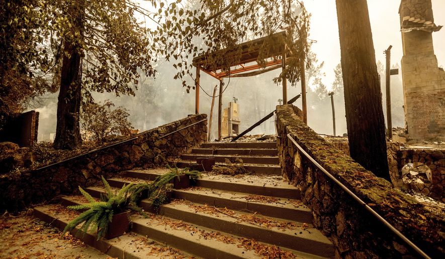 FILE - In this Sept. 28, 2020, file photo, a staircase remains at the Restaurant at Meadowood, which burned in the Glass Fire, in St. Helena, Calif.  Harvest season in Northern California&#39;s wine country draws millions of visitors each year. But harvest season now overlaps with fire season as wildfires, too, have become a yearly reality in the region. In three of the past four years, major wildfires driven by changing climate have devastated parts of the world-class region, leaving little doubt that its vulnerable to smoke, flames and blackouts during the fall. (AP Photo/Noah Berger, File)