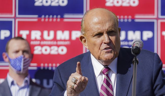 Former New York mayor Rudy Giuliani, a lawyer for President Donald Trump, speaks during a news conference at Four Seasons Total Landscaping on legal challenges to vote counting in Pennsylvania, Saturday Nov. 7, 2020, in Philadelphia. **FILE**