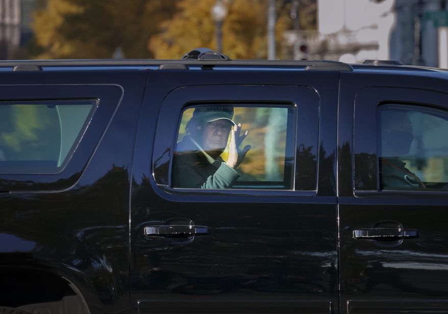 President Donald Trump waves to supporters as his motorcade arrives at the White House after golfing at his Trump National Golf Club in Sterling, Va., in Washington, Sunday, Nov. 8, 2020, a day after was defeated by President-elect Joe Biden. (AP Photo/J. Scott Applewhite)