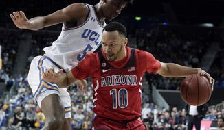 FILE - In this Feb. 29, 2020, file photo, Arizona guard Jemarl Baker Jr. drives to the basket past UCLA guard Chris Smith during the first half of an NCAA college basketball game in Los Angeles. Baker Jr., Ira Lee and Christian Koloko are the only returning players to Arizona who had significant playing time last season. (AP Photo/Chris Carlson, File)