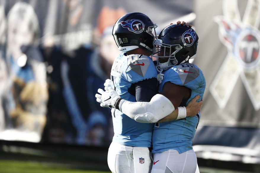 Tennessee Titans tight end Jonnu Smith, right, is congratulated by quarterback Ryan Tannehill, left, after they teamed up on a 2-yard touchdown pass play against the Chicago Bears in the second half of an NFL football game Sunday, Nov. 8, 2020, in Nashville, Tenn. (AP Photo/Wade Payne)