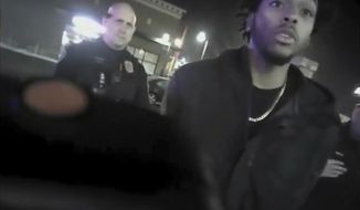 FILE - This file photo from Jan. 26, 2018, shows police body-camera footage released by Milwaukee Police Department that shows NBA Bucks guard Sterling Brown talking to arresting police officers after being shot by a stun gun in a Walgreens parking lot in Milwaukee. The Milwaukee city attorney is recommending a revised offer to settle a lawsuit brought by Milwaukee Bucks’ guard Sterling Brown, who was taken to the ground, shocked with a Taser and arrested during an encounter with police in 2018. City Attorney Tearman Spencer is recommending a $750,000 payment and an admission that Brown&#39;s constitutional rights were violated during the arrest. (Milwaukee Police Department via AP, File)