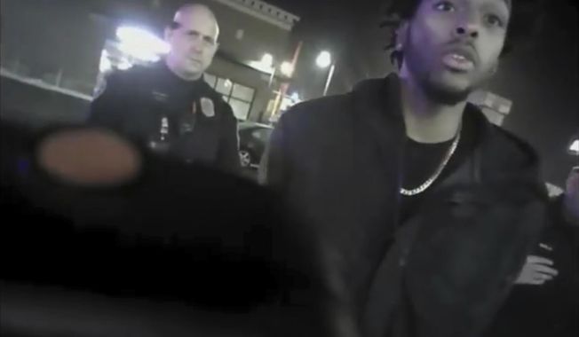 FILE - This file photo from Jan. 26, 2018, shows police body-camera footage released by Milwaukee Police Department that shows NBA Bucks guard Sterling Brown talking to arresting police officers after being shot by a stun gun in a Walgreens parking lot in Milwaukee. The Milwaukee city attorney is recommending a revised offer to settle a lawsuit brought by Milwaukee Bucks’ guard Sterling Brown, who was taken to the ground, shocked with a Taser and arrested during an encounter with police in 2018. City Attorney Tearman Spencer is recommending a $750,000 payment and an admission that Brown&#x27;s constitutional rights were violated during the arrest. (Milwaukee Police Department via AP, File)
