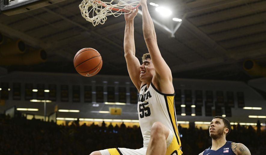 FILE - Iowa's Luka Garza (55) dunks the ball as Penn State's Myles Dread (2) looks on during the second half of an NCAA college basketball game in Iowa City, Iowa, in this Saturday, Feb. 29, 2020, file photo. Iowa will begin the college basketball season at No. 5 in the preseason AP Top 25 poll released Monday, Nov. 9, 2020.(AP Photo/Cliff Jette, File)