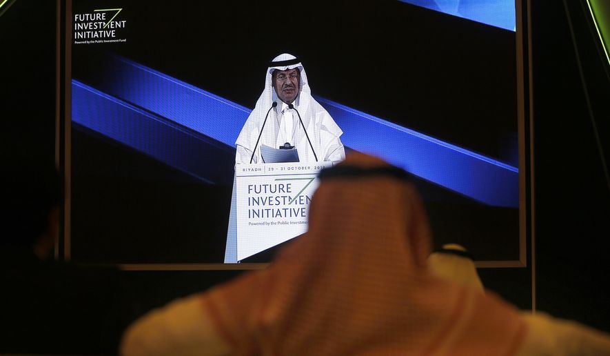 FILE - In this Oct. 30, 2019 file photo, participants watch Saudi Energy Minister Prince Abdulaziz bin Salman on a screen during his speech at the Future Investment Initiative Forum, in Riyadh, Saudi Arabia. The minister said Monday, Nov. 9, 2020, that global energy producers have the ability to tweak an agreement on production cuts that could be extended through the end of 2022, signaling the anticipation of continued weakened demand for crude as the coronavirus pandemic impacts consumption and grounds air travel for many. (AP Photo/Amr Nabil, File)