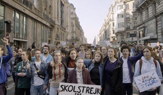 This image released by Hulu shows activist Greta Thunberg, center, in a scene from the documentary &amp;quot;I Am Greta.&amp;quot;  The film premieres Friday on Hulu. (Hulu via AP)