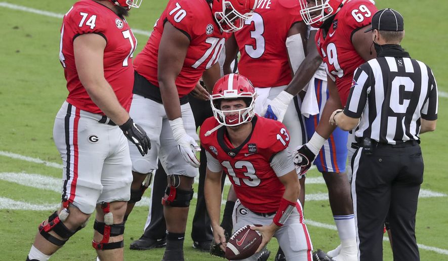 Georgia quarterback Stetson Bennett (13) gets up after he recovered his own fumble against Georgia during the first half of a NCAA college football, Saturday, Nov. 7, 2020, in Jacksonville, Fla. (Curtis Compton/Atlanta Journal-Constitution via AP)