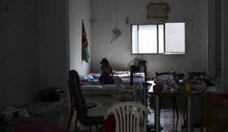 Natasha, a Kenyan migrant worker sits in a shelter where she is staying with other migrants, in Mkalles, Lebanon, Oct. 9, 2020. Two young Lebanese are on a mission to repatriate migrant workers who have been stranded in Lebanon amid the worst economic crisis in the country’s modern history. In two months, they have sent more than 120 women, mostly Kenyans and some Ethiopians, back home, fundraising more than $35,000 for flights and coronavirus tests. (AP Photo/Hassan Ammar)