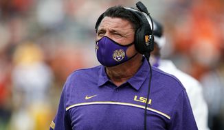 LSU head coach Ed Orgeron walks the sideline during the first quarter of an NCAA college football game against Auburn on Saturday, Oct. 31, 2020, in Auburn, Ala. (AP Photo/Butch Dill)