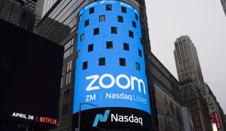 This April 18, 2019, photo shows a sign for Zoom Video Communications ahead of the company&#39;s Nasdaq IPO in New York. In 2020, Zoom stock surged 425% according to a Motley Fool analysis, with other competitors rushing to keep up with the working-from-home boom. (AP Photo/Mark Lennihan) **FILE**
