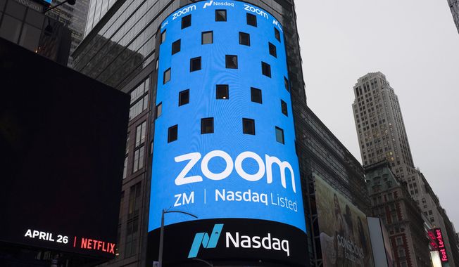 This April 18, 2019, photo shows a sign for Zoom Video Communications ahead of the company&#x27;s Nasdaq IPO in New York. In 2020, Zoom stock surged 425% according to a Motley Fool analysis, with other competitors rushing to keep up with the working-from-home boom. (AP Photo/Mark Lennihan) **FILE**