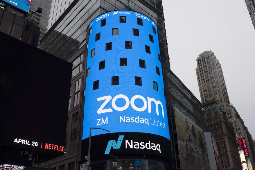 This April 18, 2019, photo shows a sign for Zoom Video Communications ahead of the company&#39;s Nasdaq IPO in New York. In 2020, Zoom stock surged 425% according to a Motley Fool analysis, with other competitors rushing to keep up with the working-from-home boom. (AP Photo/Mark Lennihan) **FILE**