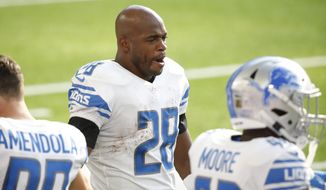 Detroit Lions running back Adrian Peterson (28) watches from the sideline during the first half of an NFL football game against the Minnesota Vikings, Sunday, Nov. 8, 2020, in Minneapolis. (AP Photo/Bruce Kluckhohn)