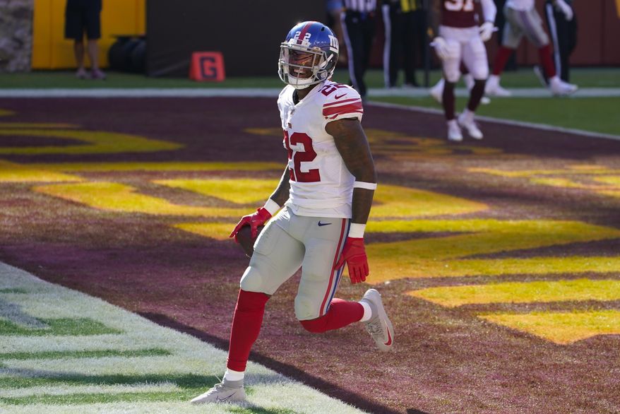 New York Giants running back Wayne Gallman (22) smiles as he scores a touchdown against Washington Football Team in the first half of an NFL football game, Sunday, Nov. 8, 2020, in Landover, Md. (AP Photo/Patrick Semansky)