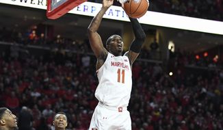 FILE - Maryland guard Darryl Morsell (11) goes to the basket for a slam dunk during the second half of an NCAA college basketball game against Michigan State in College Park, Md., in this Saturday, Feb. 29, 2020, file photo. (AP Photo/Terrance Williams, File)