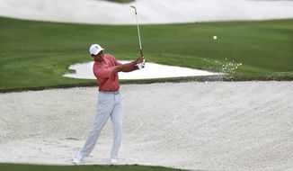 Tiger Woods practices on his sand shots on the practice range at Augusta National Golf Club in Augusta, Ga., Tuesday, Nov 10, 2020. The Masters golf tournament begins Thursday in Augusta. (Curtis ComptonAtlanta Journal-Constitution via AP)