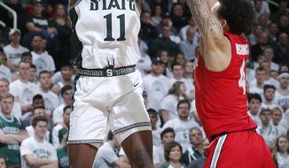 FILE - Michigan State&#39;s Aaron Henry, left, shoots against Ohio State&#39;s Duane Washington Jr. during the second half of an NCAA college basketball game in East Lansing, Mich., in this Sunday, March 8, 2020, file photo. Michigan State won 80-69. The team will need preseason All-Big Ten player Aaron Henry to produce much more than he has in the past as a role player.(AP Photo/Al Goldis, File)