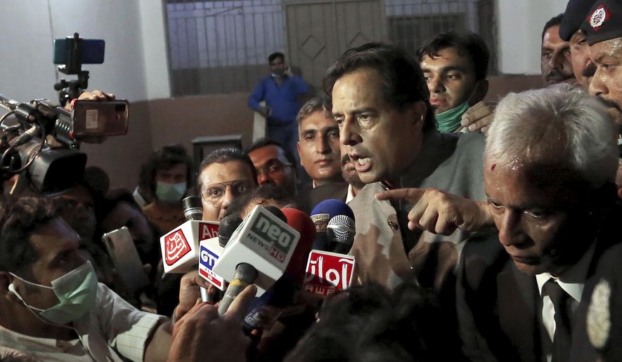 FILE - In this Oct. 19, 2020 file photo, Mohammad Safdar, center, son-in-law of exiled former Pakistani Prime Minister Nawaz Sharif, gestures as he speaks to journalists after a court granted him bail, outside a court in Karachi, Pakistan. Pakistan’s military Tuesday announced the suspension of an unspecified number of intelligence officers and troops accused last month by opposition leaders of abducting a provincial police chief to pressure him to arrest Safdar. Nawaz Sharif. (AP Photo/Fareed Khan, File)