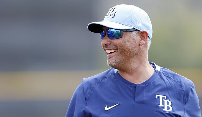 FILE  - In this Feb. 13, 2020, file photo, Tampa Bay Rays manager Kevin Cash takes the practice field during the start of baseball spring training in Port Charlotte, Fla. Cash was named AL manager of the year Tuesday night, Nov. 10, 2020. (Octavio Jones/Tampa Bay Times via AP, File)
