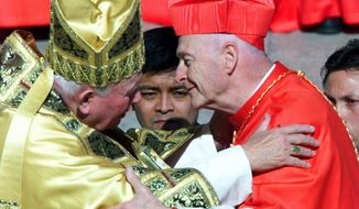 FILE - In this Feb. 21, 2001 file photo, Cardinal Theodore Edgar McCarrick, archbishop of Washington D.C., wearing the three-cornered biretta hat, embraces Pope John Paul II in St. Peter&#39;s Square at the Vatican. In a sunlit ceremony of ancient ritual in St. Peter&#39;s Square, Pope John Paul II installed a record number of cardinals - 44 new princes of the Roman Catholic Church. (AP Photo/Jerome Delay, File)