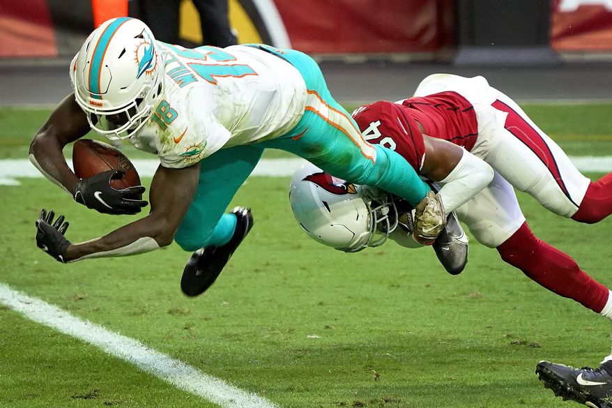 Miami Dolphins wide receiver Preston Williams (18) falls in for a touchdown as Arizona Cardinals free safety Jalen Thompson (34) defends during the first half of an NFL football game, Sunday, Nov. 8, 2020, in Glendale, Ariz. (AP Photo/Rick Scuteri)