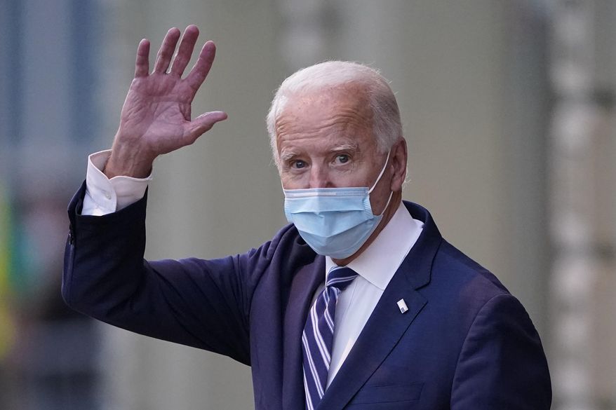 President-elect Joe Biden wavs as he leaves The Queen theater, Tuesday, Nov. 10, 2020, in Wilmington, Del. (AP Photo/Carolyn Kaster)