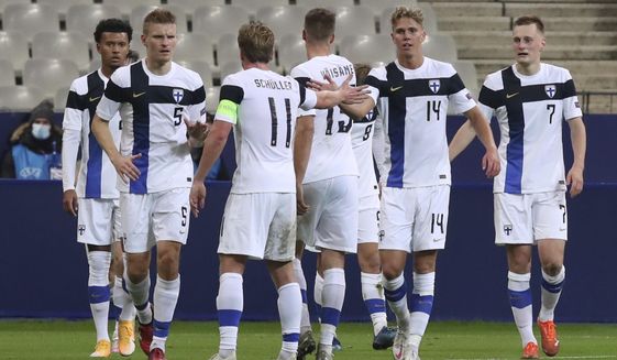 Finland&#39;s Onni Valakari, second right, is congratulated by teammates after scoring the team&#39;s second goal during the international friendly soccer match between France and Sweden at the Stade de France stadium in Saint-Denis, outside Paris, Wednesday Nov.11, 2020. (AP Photo/Michel Euler)