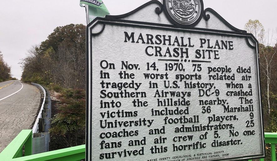 A memorial plaque is displayed at the site of a 1970 plane crash that killed 75 people, including 36 Marshall football players Oct. 24, 2020, near Huntington, W.Va. The Nov. 14, 1970 crash remains the worst sports disaster in U.S. history. (AP Photo/John Raby)
