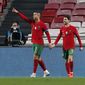 Portugal&#39;s Cristiano Ronaldo, left, is congratulated by teammate Bernardo Silva after scoring his teams sixth goal during the international friendly soccer match between Portugal and Andorra at the Luz stadium in Lisbon, Portugal, Wednesday, Nov. 11, 2020. (AP Photo/Armando Franca)