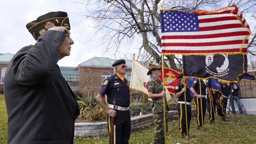 Chaplain Charles Andriolo, of VFW Post 1617, salutes during a Veteran's Day ceremony, Wednesday, Nov. 11, 2020, in Derry, N.H. (AP Photo/Charles Krupa)