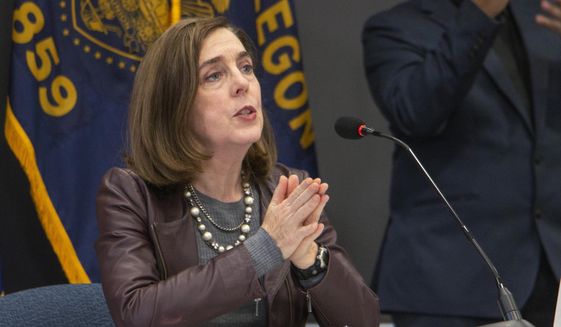 Oregon Gov. Kate Brown speaks Tuesday, Nov. 10, 2020, in Portland, Ore. Brown and Oregon health officials warned Tuesday of the capacity challenges facing hospitals as COVID-19 case counts continue to spike in the state. (Cathy Cheney/Pool Photo via AP)