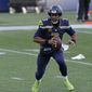 Seattle Seahawks quarterback Russell Wilson scrambles to pass against the San Francisco 49ers during the second half of an NFL football game, Sunday, Nov. 1, 2020, in Seattle. (AP Photo/Elaine Thompson)
