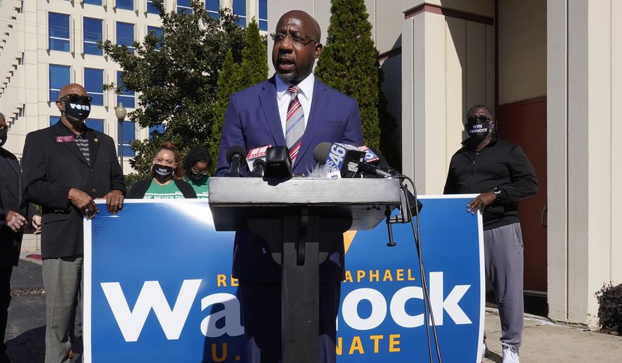 Georgia Democratic candidate for U.S. Senate Raphael Warnock speaks during a news conference Thursday, Nov. 12, 2020, in Atlanta.  Control of the Senate won’t be decided until January runoffs in Georgia after neither party Wednesday locked down a majority, launching a mammoth battle to shape President-elect Joe Biden&#39;s agenda and determine the balance of power in Washington. (AP Photo/John Bazemore)