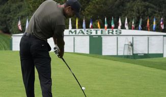 Tiger Woods tees off on the first hole during the first round of the Masters golf tournament Thursday, Nov. 12, 2020, in Augusta, Ga. (AP Photo/David J. Phillip)