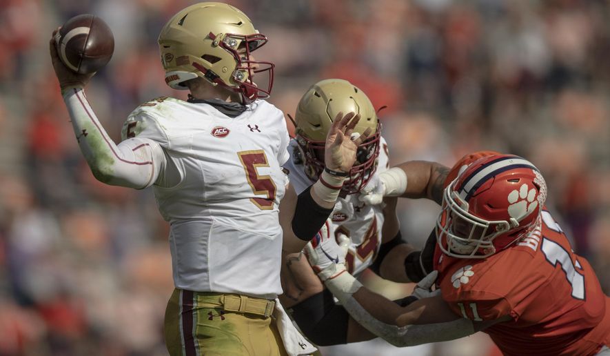 Boston College quarterback Phil Jurkovec (5) passes the ball near Clemson defensive lineman Bryan Bresee (11) during the first half of an NCAA college football game Saturday, Oct. 31, 2020, in Clemson, S.C. (Josh Morgan/Pool Photo via AP)