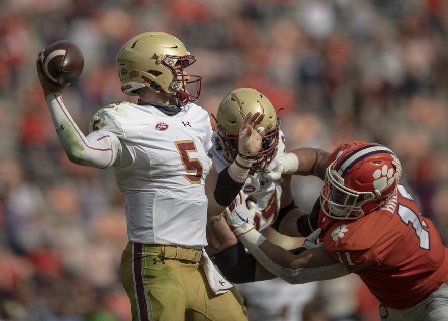 Boston College quarterback Phil Jurkovec (5) passes the ball near Clemson defensive lineman Bryan Bresee (11) during the first half of an NCAA college football game Saturday, Oct. 31, 2020, in Clemson, S.C. (Josh Morgan/Pool Photo via AP)