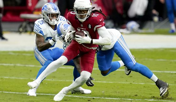 FILE - In this  Sunday, Sept. 27, 2020 file photo, Arizona Cardinals wide receiver DeAndre Hopkins (10) is hit by Detroit Lions outside linebacker Christian Jones during the first half of an NFL football game in Glendale, Ariz. Buffalo&#39;s Stefon Diggs and Arizona&#39;s DeAndre Hopkins are two receivers who have flourished in their new homes after being traded to their respective teams just hours apart in March. The Bills travel to face the Cardinals in a game that&#39;s vital for both teams in their chase for the playoffs, Sunday, Nov. 15, 2020. (AP Photo/Ross D. Franklin, File)