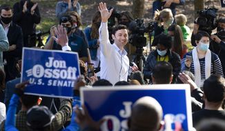 Georgia Democratic candidate for U.S. Senate Jon Ossoff rallies supporters for a run-off against Republican candidate Sen. David Perdue, as they meet in Grant Park, Friday, Nov. 6, 2020, in Atlanta. (AP Photo/John Amis)