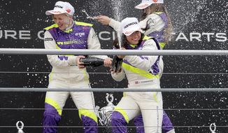 FILE - In this Saturday, May 4, 2018 file photo, Jamie Chadwick, center, celebrates with Alice Powell, left, and Marta Garcia after she wins the inaugural car race of the new all-female W Series at Hockenheim, Germany. Formula One world champion Lewis Hamilton praised the decision to host eight races of the all-female W Series alongside F1 races next season, calling it an important step in the push for greater diversity and inclusion in motorsport. “When we talk about diversity people often think that we’re talking about having more people of color. It’s not just that,&amp;quot; Hamilton said Thursday, Nov. 12, 2020 at the Turkish F1 GP in Istanbul. “It is having more women involved. At the moment it is a male dominated sport and that does need to change.” (Hasan Bratic/dpa via AP, file)