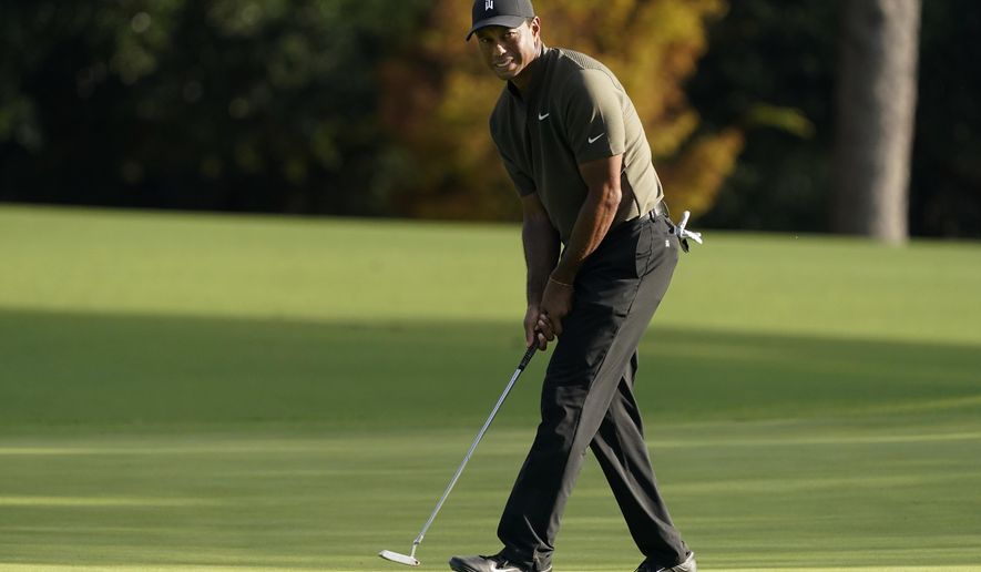 Tiger Woods watches his ball as he misses a birdie putt on the eighth hole during the first round of the Masters golf tournament Thursday, Nov. 12, 2020, in Augusta, Ga. (AP Photo/Charlie Riedel)