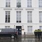 Dutch police are seen outside Saudi Arabia&#x27;s embassy in The Hague, Netherlands, Thursday, Nov. 12, 2020, after several shot were fired at the building early in the morning. Nobody was injured and police were investigating. (AP Photo/Mike Corder)