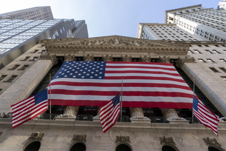 FILE - In this Monday, Sept. 21, 2020, file photo, a giant American Flag hangs on the New York Stock Exchange.  Wall Street is moving past the uncertainty of election season and, if history is a guide, investors can indeed breathe a sigh of relief. Stocks typically post solid gains following an election, no matter which party controls the White House or Congress.  (AP Photo/Mary Altaffer, File)