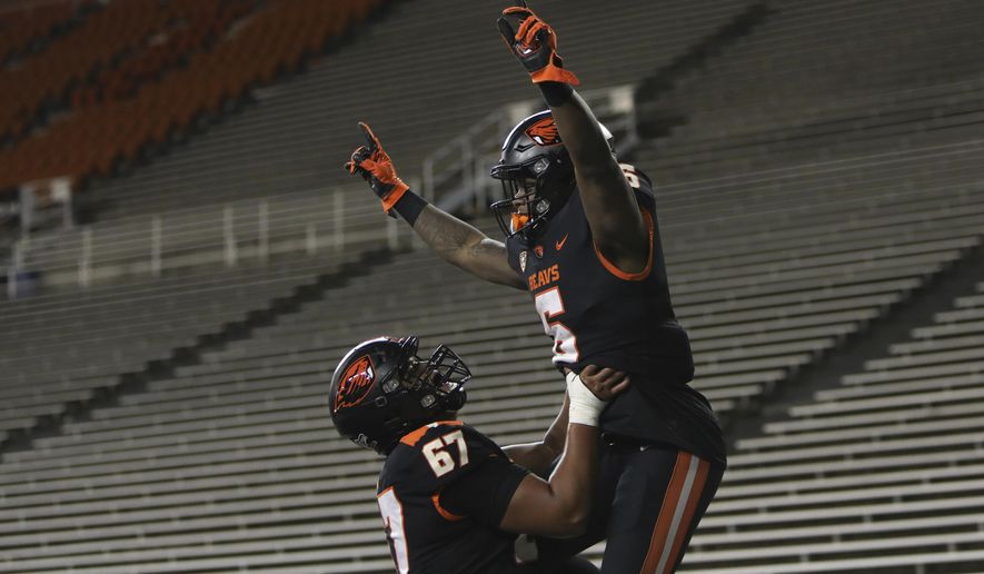 Oregon State offensive linesman Joshua Gray (67) lifts Oregon State running back Jermar Jefferson (6) into the air after Jefferson scored a touchdown during the second half of an NCAA college football game against Washington State in Corvallis, Ore., Saturday, Nov. 7, 2020. Washington State won 38-28. (AP Photo/Amanda Loman)