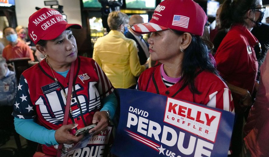 Republican supporters wait for U.S. Senate Sen. Kelly Loeffler, and Sen. David Perdue to speak during a campaign rally on Friday, Nov. 13, 2020, in Cumming, Ga. (AP Photo/Brynn Anderson) **FILE**