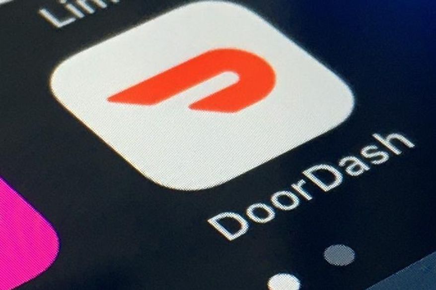 FILE - The DoorDash app is shown on a smartphone on Thursday, Feb. 27, 2020 in New York.  DoorDash Inc. is planning to sell its stock to the public, capitalizing on the growing trend of consumers embracing app-based deliveries as much of the world stays home during the pandemic. The company filed papers signaling its intent for initial public offering Friday, Nov. 13.  (AP Photo)